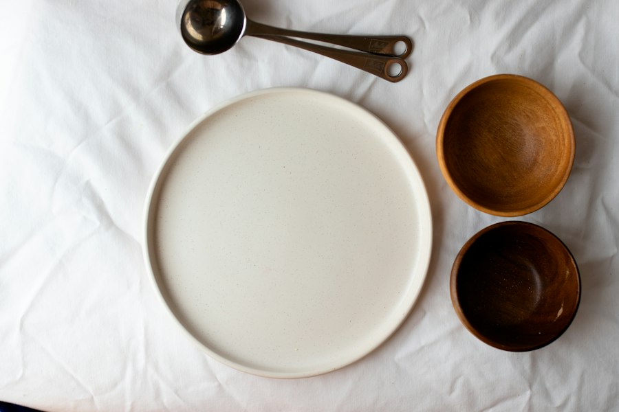 Ceramic plate and timber bowls on linen